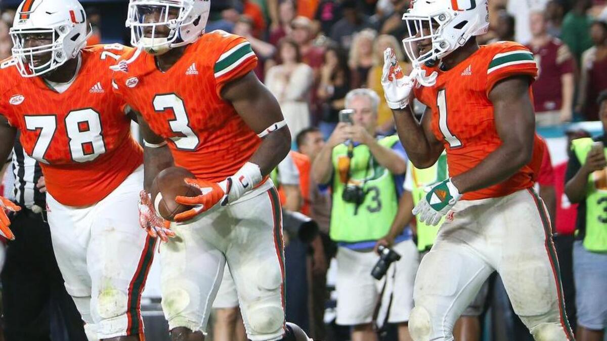 University of Miami Hurricanes wide receiver Stacy Coley, #3, celebrates with teammates offensive linemen Tyree St. Louis,78, and Mark Walton,1, after scoring a touchdown against the Florida State Seminoles at Hard Rock Stadium on Saturday October 8, 2016, in Miami Gardens.