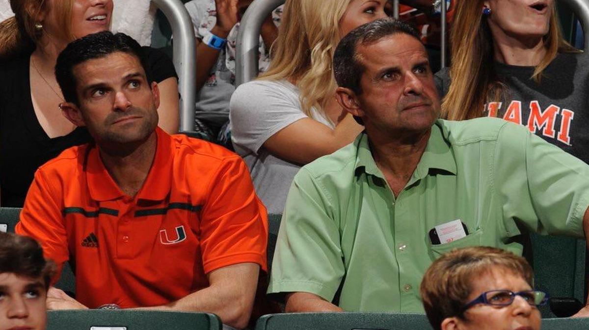 UM Defensive coordinator Manny Diaz and his father Manny Sr. Take in a UM hoops game this season