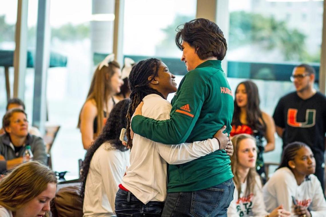 University of Miami basketball team player Mykea Gray hugs head coach Katie Meier after the public selection of the NCAA at Rathskeller in Coral Gables on Monday.