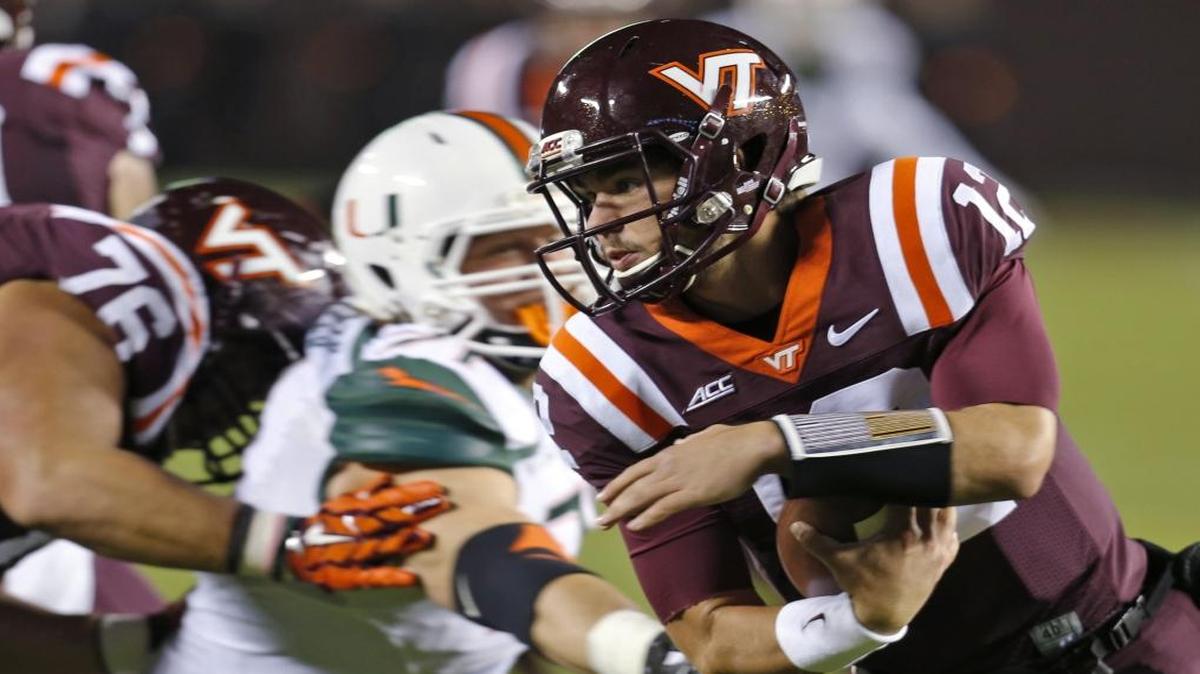 Virginia Tech quarterback Michael Brewer (12) gets away from Miami defensive lineman Anthony Chickillo during the first half of an NCAA college football game in Blacksburg, Va., Thurs., Oct. 23, 2014. The Hurricanes are 3-0 on ESPN Thursday night games against Virginia Tech.