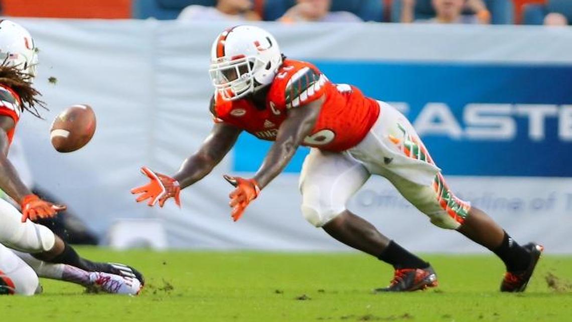 University of Miami safety Sheldrick Redwine (22) and Rayshawn Jenkins (26) battle for a loose ball against the FAU Owls on Saturday Sept. 10, 2016, in Miami Gardens.