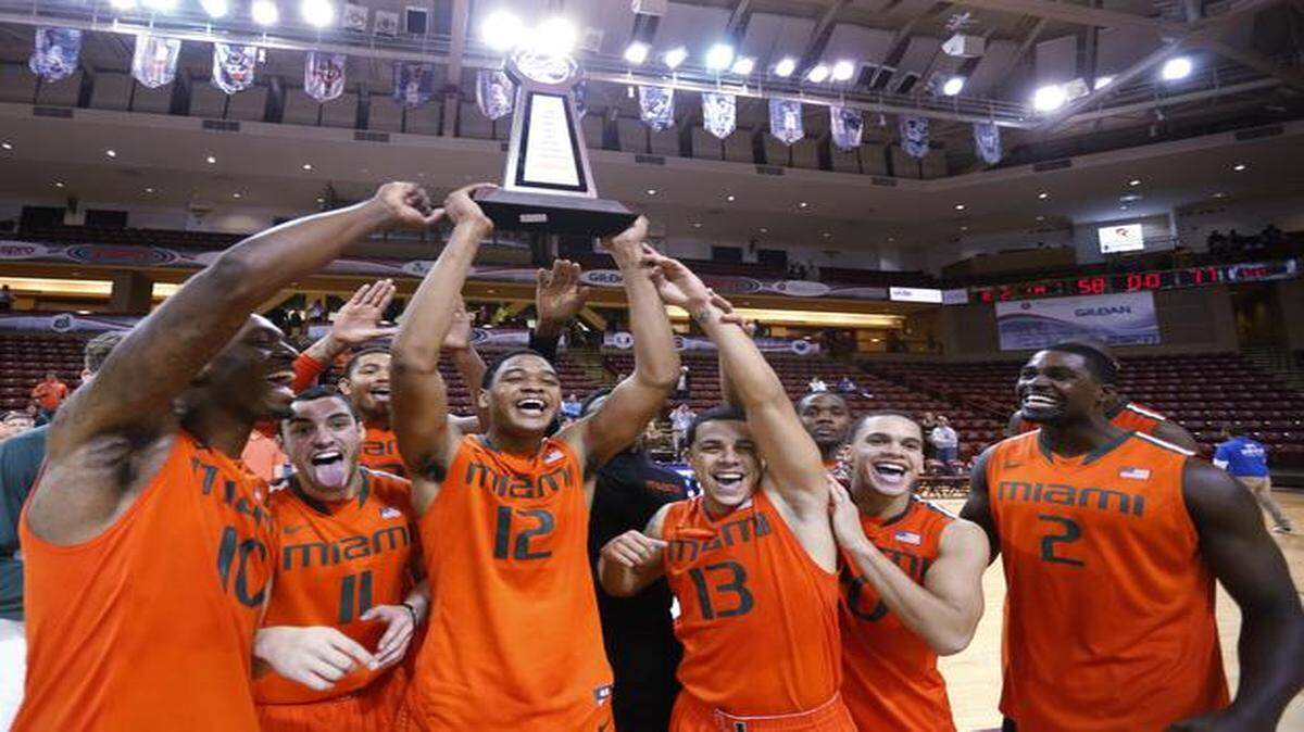 
UM players hold the trophy after defeating Charlotte in the championship game at the Charleston Classic in Charleston, S.C., Sunday, Nov. 23, 2014. 
