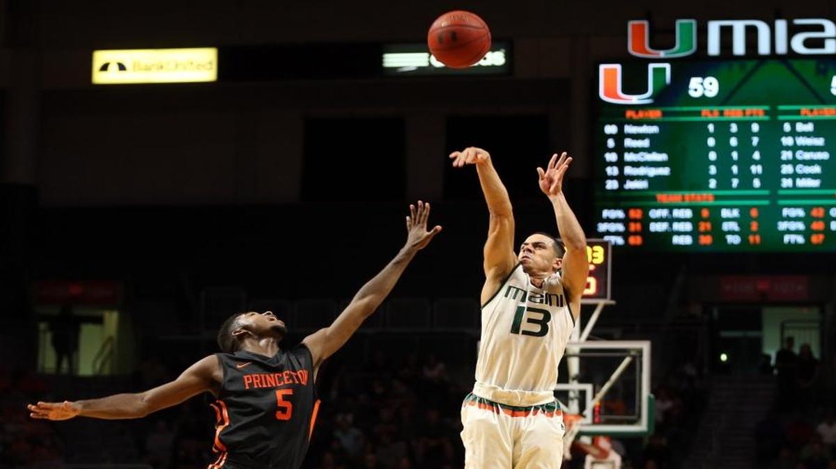 UM’s Angel Rodriguez shoots a three pointer over Princeton’s Amir Bell in the second half of a game at Bank United Center on Tuesday, December 29, 2015.