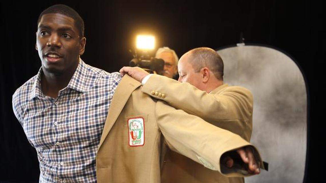 Jonathan Vilma puts on his Hall of Fame jacket for a photo session at the UM Sports Hall of Fame induction ceremony at Jungle Island in April 2015. Vilma, a former All-American linebacker at UM and NFL Pro Bowler, was promoted to ABC’s college football studio this summer after working on ESPN2 studio shows last season.