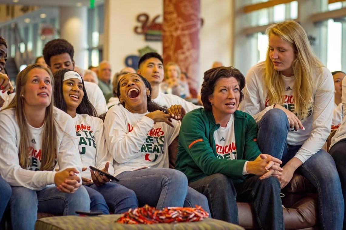 From left, University of Miami women’s basketball players Laura Cornelius, Shaneese Bailey, Erykah Davenport, head coach Katie Maier, and Emefe Hof react at the NCAA basketball selection show viewing party at the Rathskeller on UM’s Coral Gables campus.