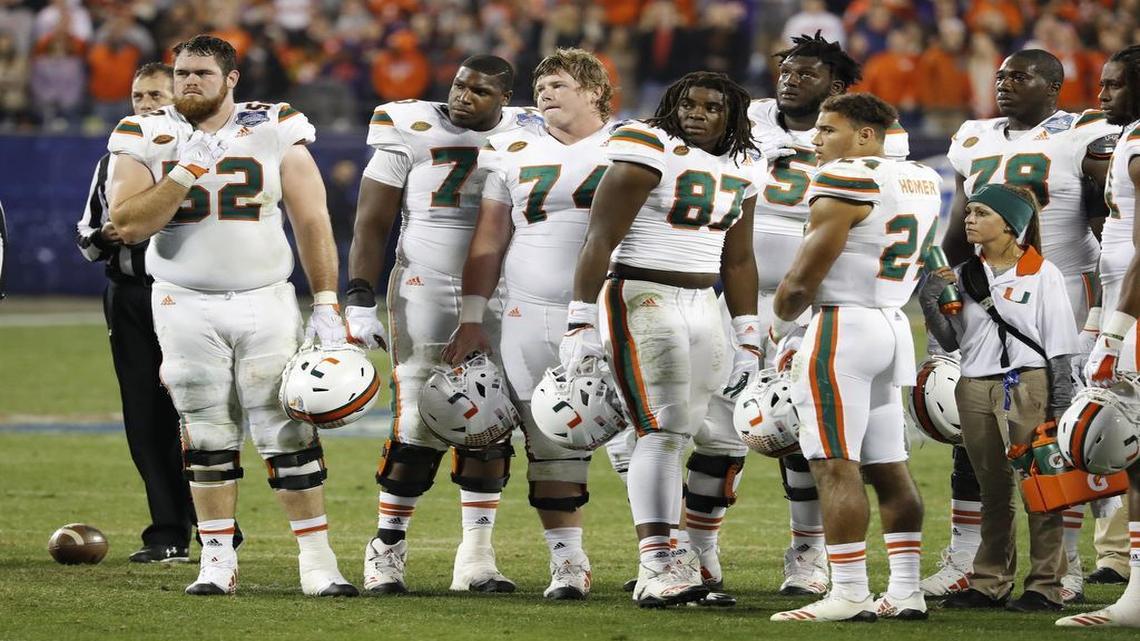 Miami offensive players, including center Tyler Gauthier (74) and current left tackle Tyree St. Louis, watch as the Hurricanes face Clemson in the ACC Championship Game at Bank of America Stadium in Charlotte, N.C. on Saturday, Dec. 2, 2017.