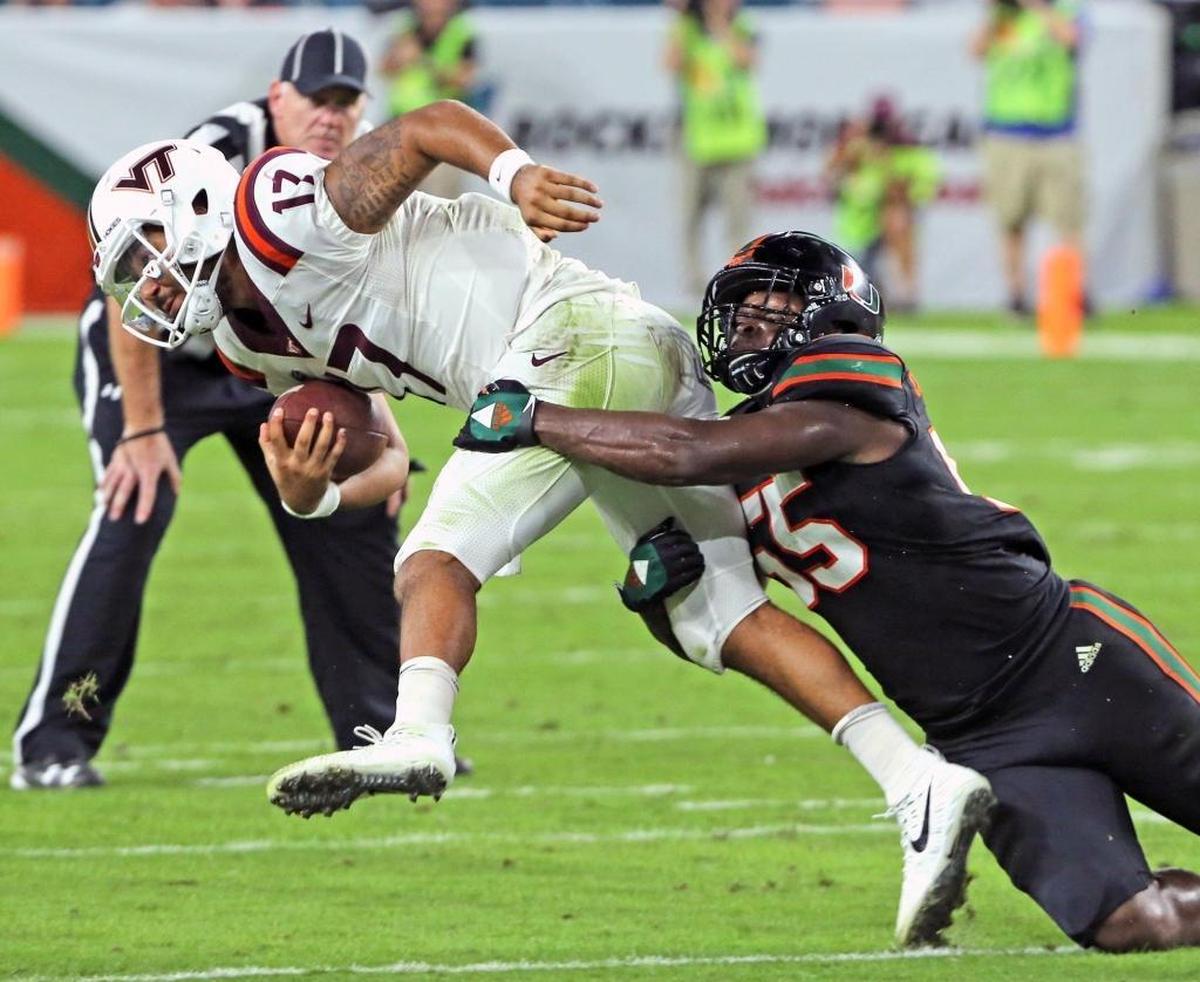 Miami Hurricanes Shaquille Quarterman (55) tackles Virginia Tech quarterback Josh Jackson (17) in the second quarter at Hard Rock Stadium in Miami Gardens on Nov. 4, 2017.