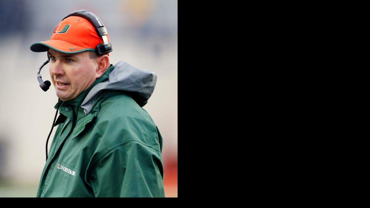 
Miami football coach Al Golden speaks into his headset in the second half of the Independence Bowl NCAA college football game against South Carolina in Shreveport, La., Saturday, Dec. 27, 2014. South Carolina won 24-21. 
