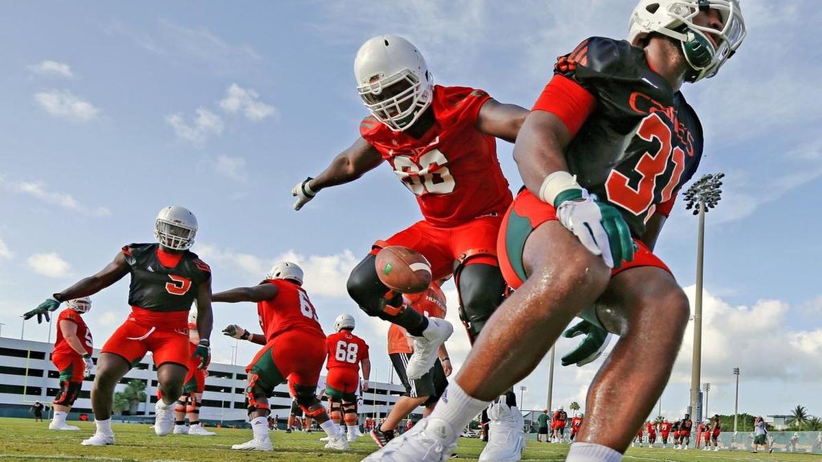 
Sunny Odogwu, center, shown working during a drill in summer practices, will be the starting right tackle for the Hurricanes.
