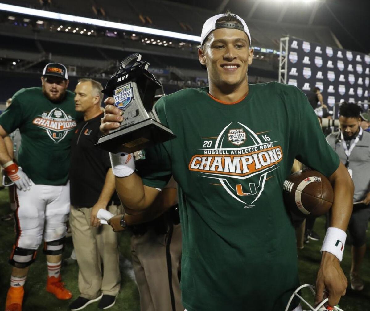 Miami Hurricanes quarterback Brad Kaaya carries his MVP trophy after Miami defeats West Virginia on December 28, 2016.