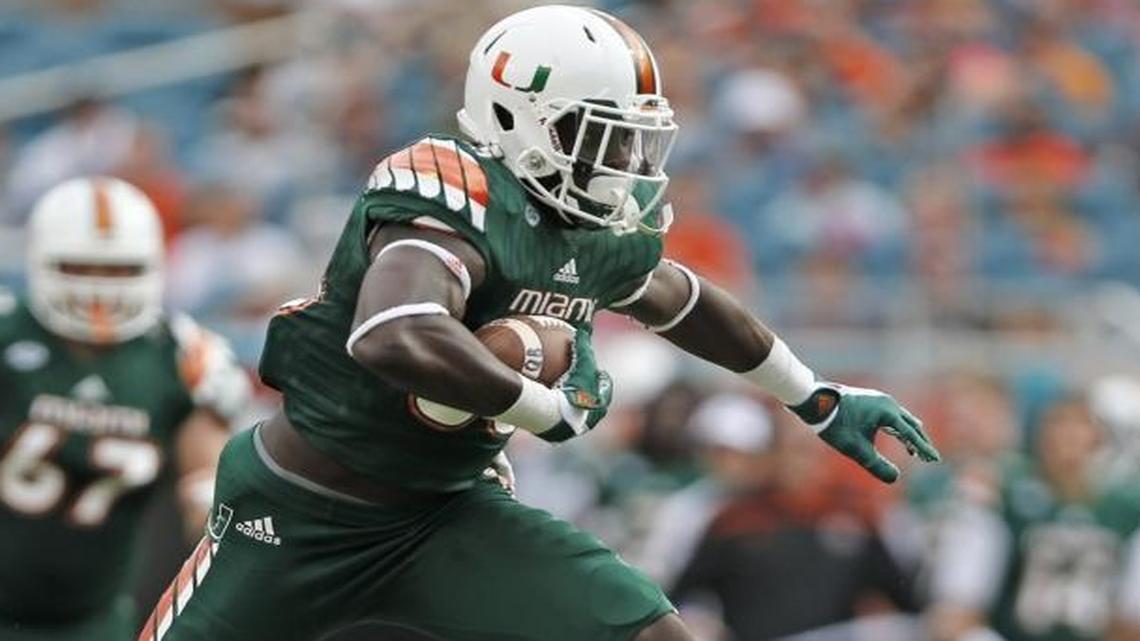 UM tight end David Njoku attempts to hurdle Virginia Tech linebacker Ronny Vandyke 37) at Sun Life Stadium in Miami on Saturday, Oct. 17, 2015.