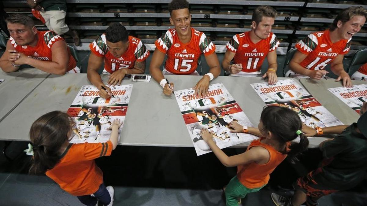 Miami Hurricanes quarterback Brad Kaaya (15) and teammates sign autographs and meet the fans during CanesFest at the BankUnited Center on UM campus on Saturday, Aug. 13, 2016.