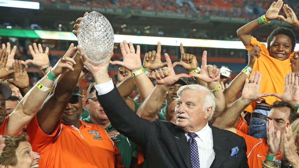 
Howard Schnellenberger raises the 1983 NCAA national championship trophy during a halftime ceremony of a game between UM and FAU in 2013.

