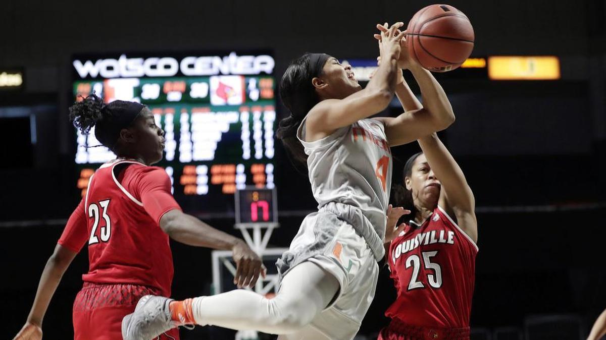 Miami’s Shaneese Bailey (4) is fouled by Louisville’s Asia Durr (25) Thursday, Jan. 25, 2018.
