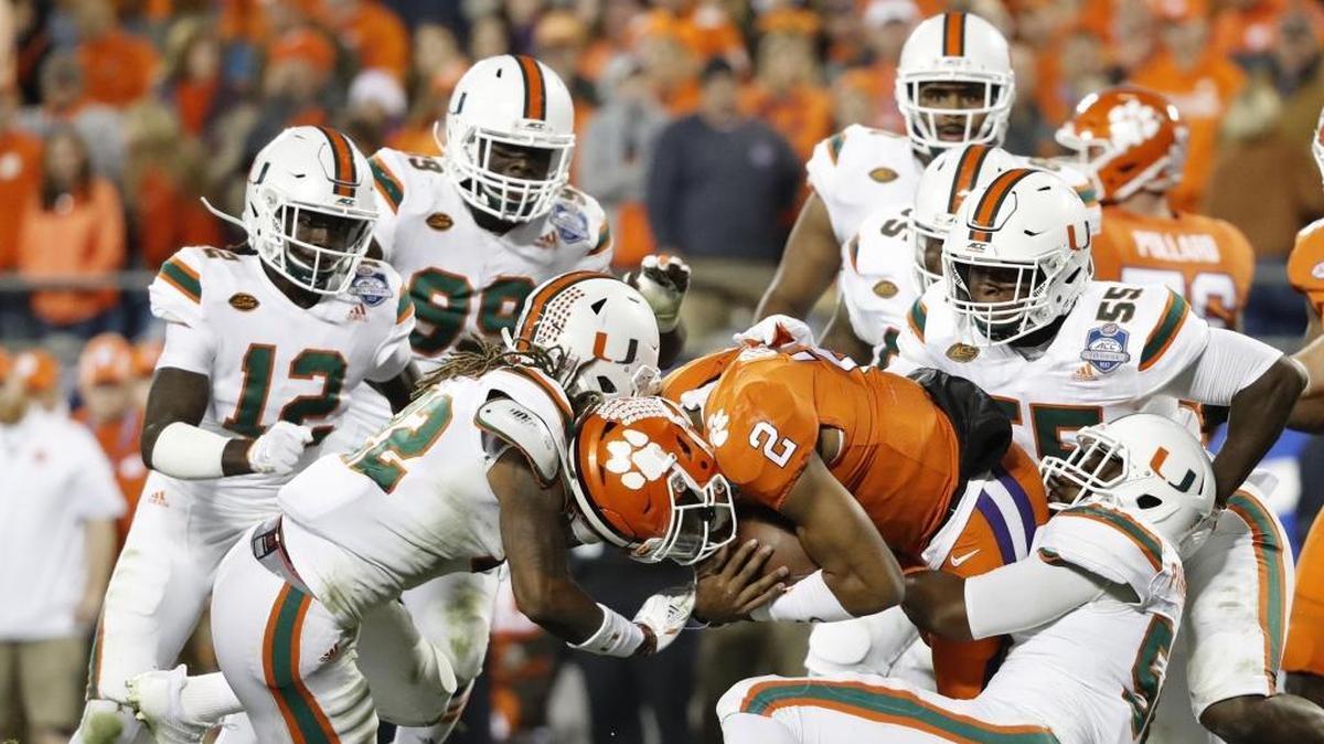 Clemson Tigers quarterback Kelly Bryant is taken down by Miami Hurricanes linebacker Michael Pinckney, linebacker Shaquille Quarterman and safety Sheldrick Redwine in the ACC Championship Game at Bank of America Stadium on Saturday, December 2, 2017.