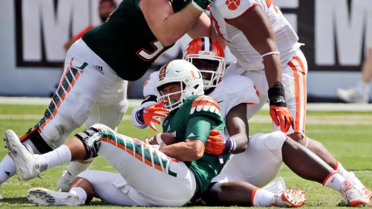 UM quarterback Brad Kaaya is sacked by Clemson’s Shaq Lawson on Saturday, Oct. 24, 2015 in Miami Gardens, Fla.