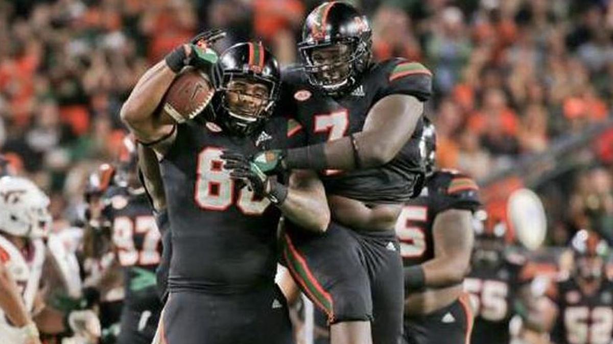 Miami Hurricanes defensive lineman RJ McIntosh (80) celebrates with teammate Miami Hurricanes defensive lineman Kendrick Norton (7) after McIntosh recovers a fumble for a turnover in the second quarter as the University of Miami hosts Virginia Tech Hokies at Hard Rock Stadium on Saturday, November 4, 2017.