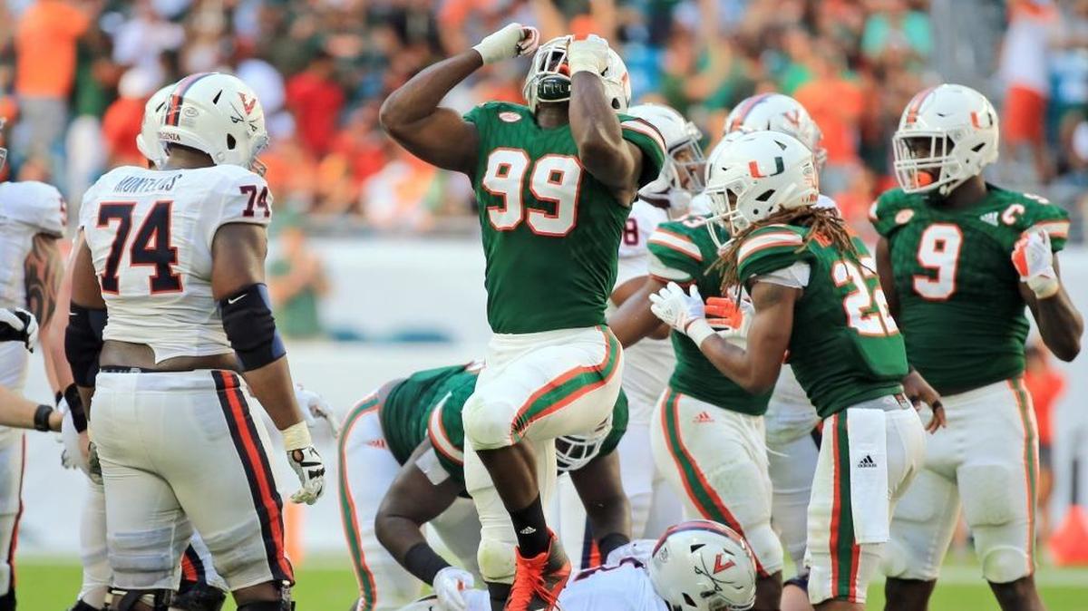 Miami Hurricanes defensive end Joe Jackson (99) reacts after taking down Virginia Cavaliers running back Jordan Ellis in the second half at Hard Rock Stadium on Saturday, November 18, 2017.