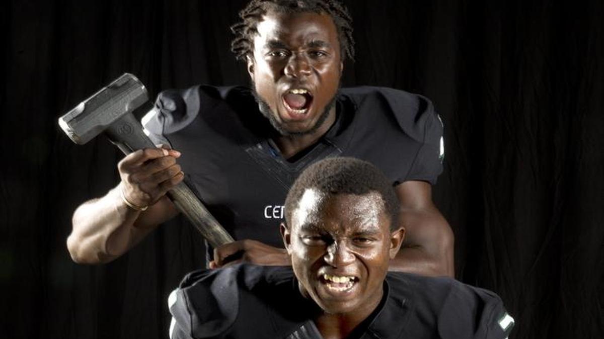 
Miami Central running backs Dalvin Cook (top) and Joe Yearby pose for a photo Aug. 15, 2013. 
