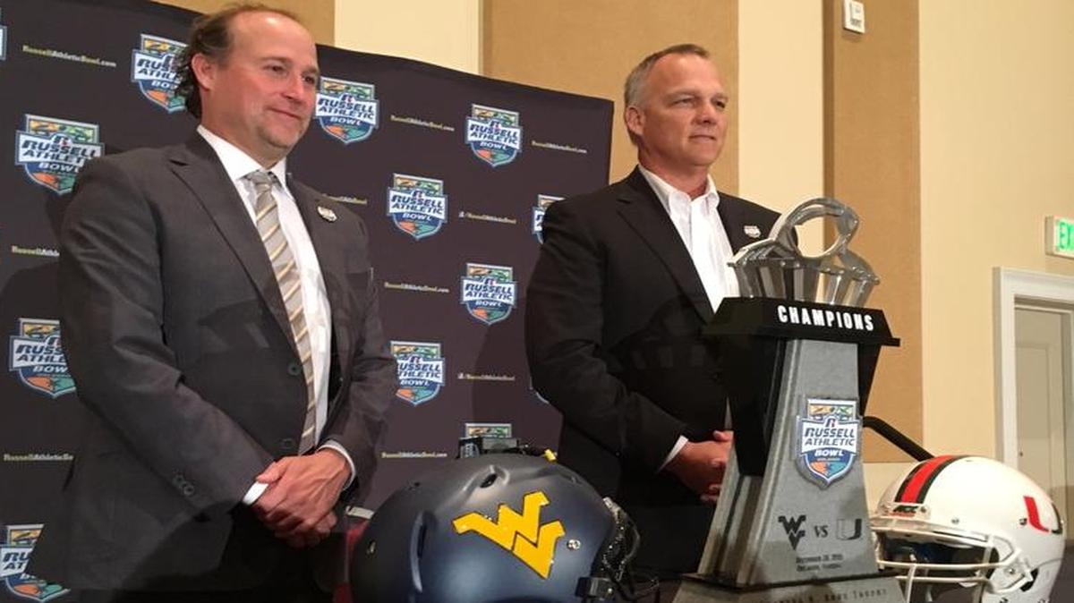 West Virginia coach Dana Holgorsen, left, and UM coach Mark Richt during a press conference for the Russell Athletic Bowl on Tues., Dec. 27, 2016.