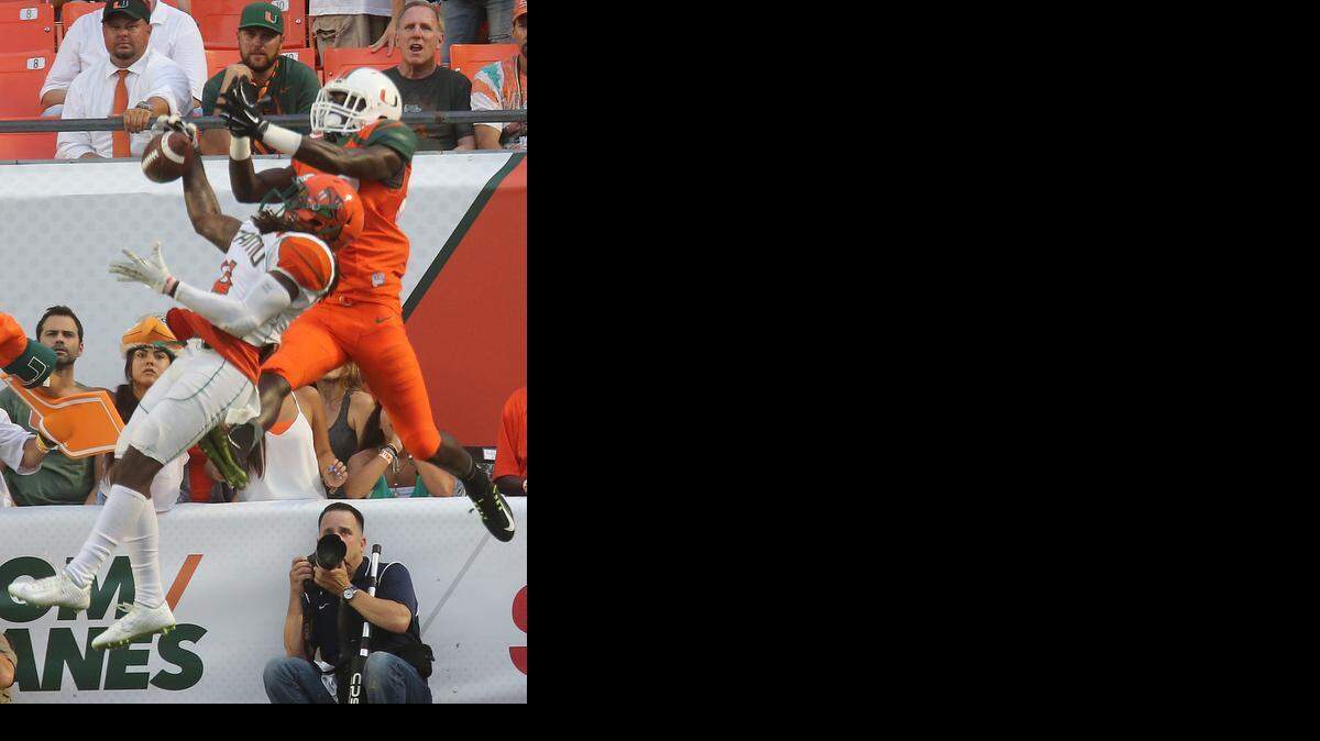 
A pass intended for UM receiver Tyre Brady is broken up by FAMU’s Patrick Aiken in the second quarter at Sun Life Stadium in Miami Gardens on Saturday, Sept. 6, 2014.
