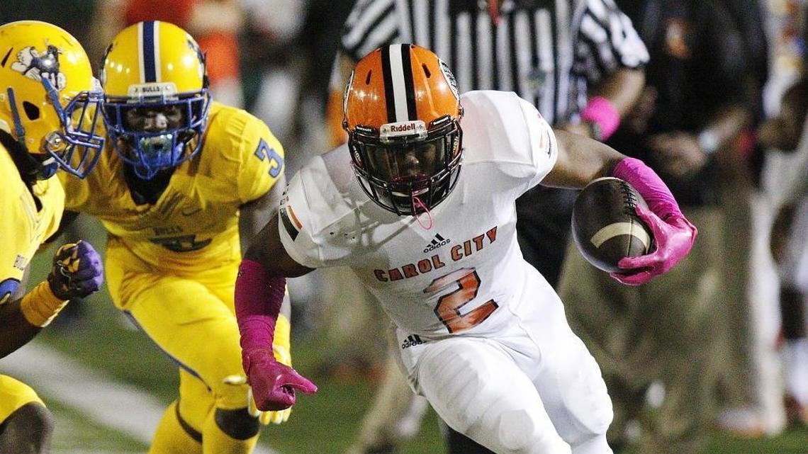 Carol City Chiefs’ running back Camron Davis rushes against the Northwestern Bulls on Thursday, Oct. 12, 2017, at Traz Powell Stadium in Miami.