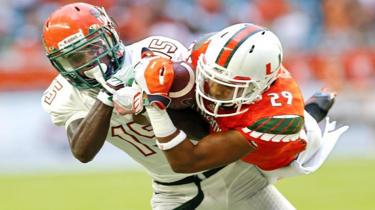 Miami Hurricanes defensive back Corn Elder (29) intercepts the ball intended for Florida A&M Rattlers wide receiver Montavius Williams (15) in the first quarter as the University of Miami hosts Florida A&M at Hard Rock Stadium on Sat., Sept. 3, 2016.