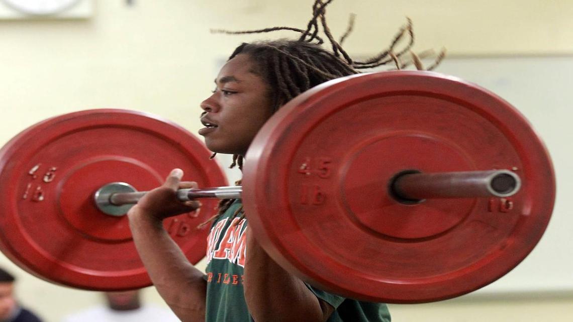 Sheldrick Redwine, shown working out with weights at Killian High just before reporting to UM, is the latest Hurricane to earn the ‘turnover chain.’
