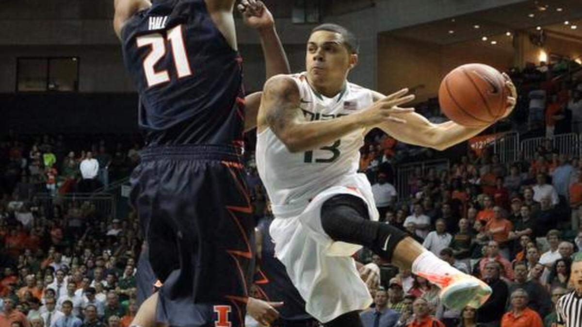 
UM guard Angel Rodriguez tries to pass around Illinois guard Malcolm Hill during Tuesday night’s game. Rodriguez finished with nine points, five assists and six rebounds in the win. 
