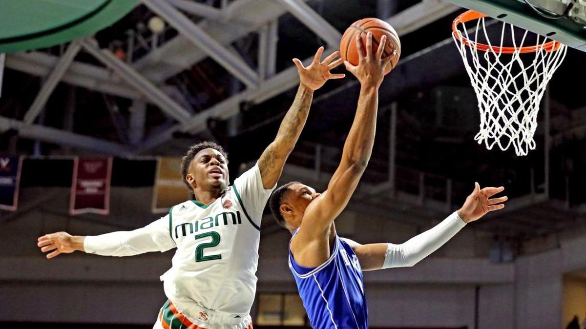 The Hurricanes’ Chris Lykes attempts to block the Blue Devils’ Trevon Duval as he drives to the basket in the second half on Monday night at the Watsco Center.