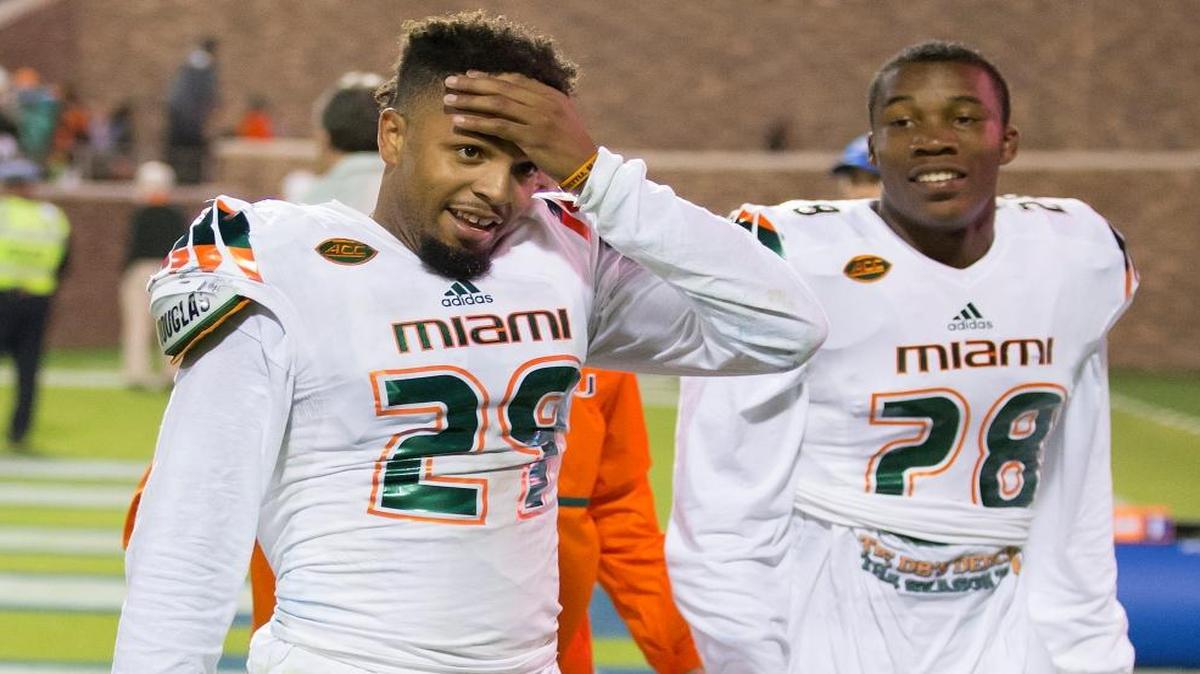 UM’s Corn Elder (29) wipes his head as he leaves the field with defensive back Michael Jackson following a kickoff return that featured eighth laterals before Elder scored to beat Duke 30-27 in Durham, N.C., Saturday, Oct. 31, 2015.