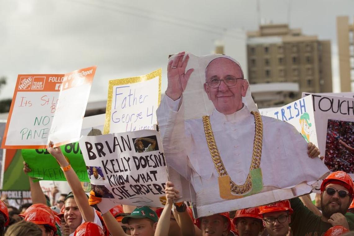 Fans cheer and wave signs during ESPN's College GameDay at the University of Miami in Coral Gables on Saturday, Nov. 11, 2017. The event took place a few hours before the University of Miami faced Notre Dame at Hard Rock Stadium.