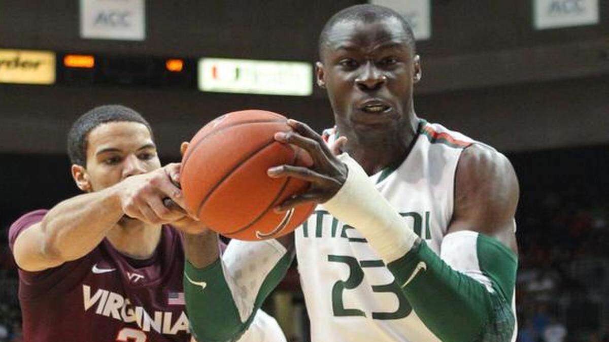 
UM’s Tonye Jekiri, right, grabs a rebound against Joey van Zegeren of Virginia Tech at BankUnited Center in Miami on Wednesday, Feb. 27, 2013.
