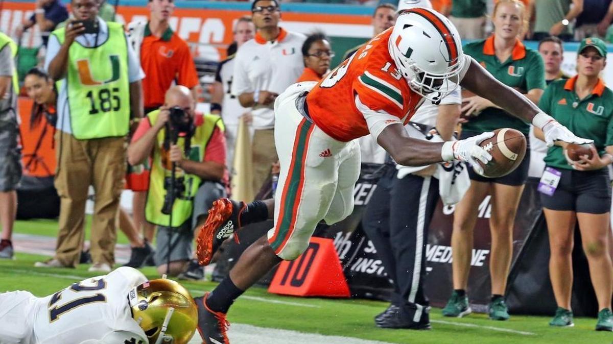 Miami Hurricanes DeeJay Dallas scores a third quarter touchdown as Notre Dame Jalen Elliot (21) fails to stop him at Hard Rock Stadium in Miami Gardens, Florida, Nov. 11, 2017.