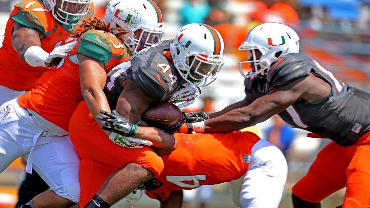 UM fullback Walter Tucker pushes for more yardage during the spring game at Lockhart Stadium in Fort Lauderdale on March 28, 2015.