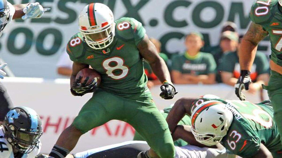
Miami Hurricanes’ Duke Johnson scrambles for yards in the first quarter as they play the North Carolina Tar Heels at Sun Life Stadium in Miami Gardens, Florida, Novemebr 1, 2014.
