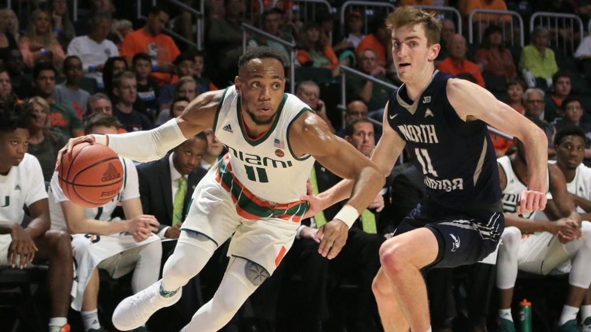 Miami Hurricanes guard Bruce Brown Jr. (11) drives the ball as North Florida Ospreys guard Garrett Sams (11) defends in the second half as the University of Miami Hurricanes host the North Florida Ospreys on Saturday, November 25, 2017.