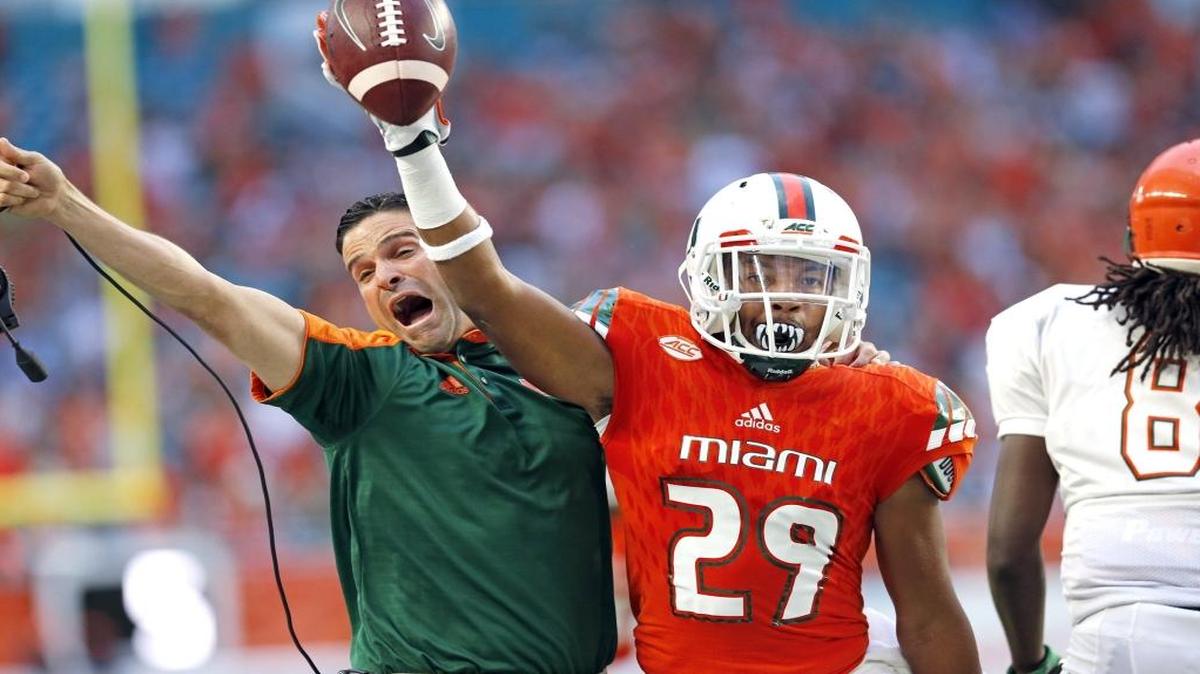 Manny Diaz celebrates after Miami Hurricanes defensive back Corn Elder (29) intercepts the ball intended for Florida A&M Rattlers wide receiver Montavius Williams (15) in the first quarter as the University of Miami hosts Florida A&M at Hard Rock Stadium on Sat., Sept. 3, 2016.