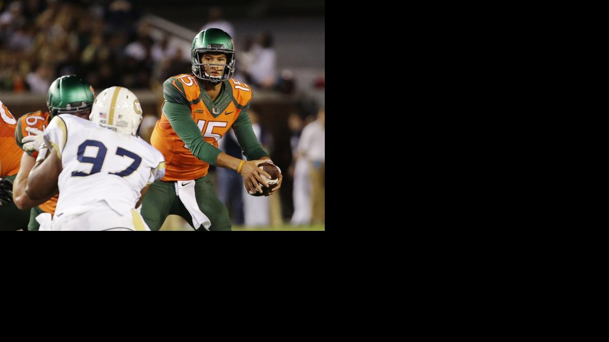 
Miami quarterback Brad Kaaya, right, looks to pass in the first half of an NCAA college football game against Georgia Tech, Saturday, Oct. 4, 2014, in Atlanta. 
