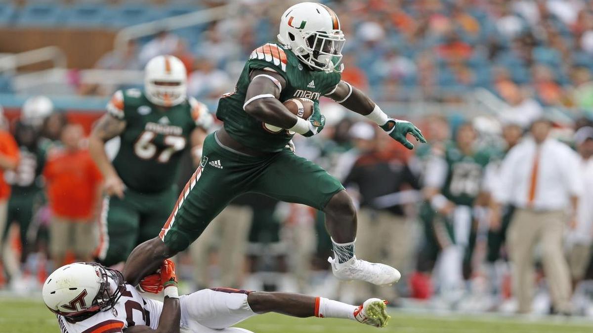 
Canes tight end David Njoku attempts to hurdle Hokies linebacker Ronny Vandyke in the first quarter of UM’s win Saturday.

