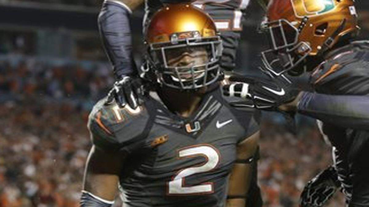 
UM safety Deon Bush (2) celebrates with Antonio Crawford (21) after intercepting FSU quarterback Jameis Winston on Saturday, Nov. 15, 2014. 
