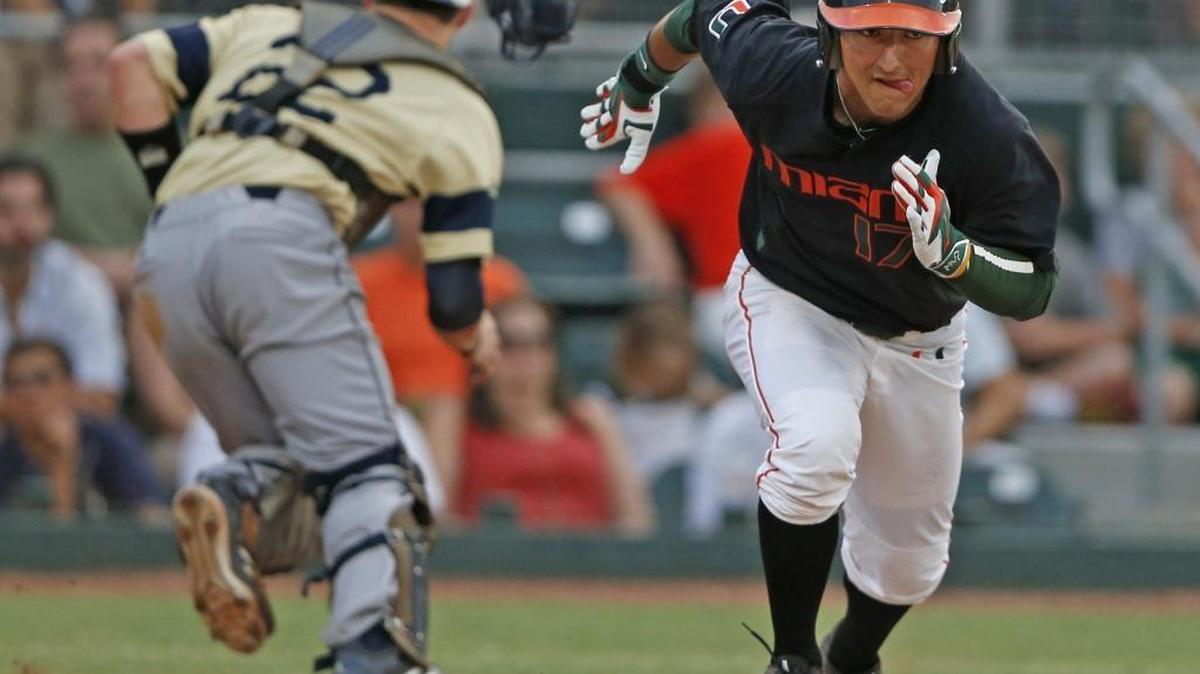 FIU catcher Zach Soria (22) chases a ground ball hit by Miami first baseman Chris Barr (17) in the second inning as UM hosted FIU in the NCAA Coral Gables Regional at Mark Light Field on May 29, 2015. The teams meet again on Wednesday, Feb. 22, at FIU.