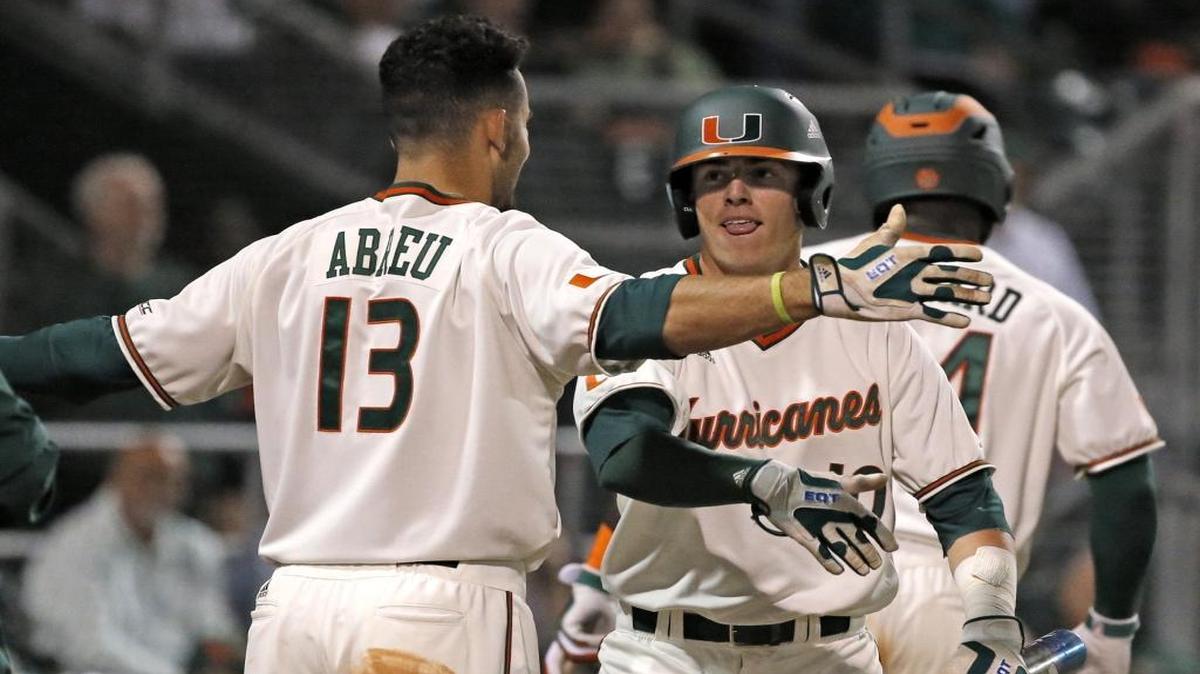 Now they’re No. 1 in the nation. Earlier this season, Miami outfielder Willie Abreu (13) congratulates Miami third baseman Romy Gonzalez (10) after scoring his first run as a freshman starter as the University of Miami opens its college baseball season at home against Rutgers University on Friday, February 19, 2016.
