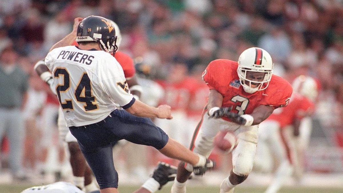 Hurricanes strong safety Tremain Mack (3) blocks a punt by West Virginia's Jon Powers (25) inside the Hurricanes 5-yard in the last minutes of the second quarter of their game on Nov. 18, 1995. Miami recovered but failed to score. Mack scored a more memorable block one year later.