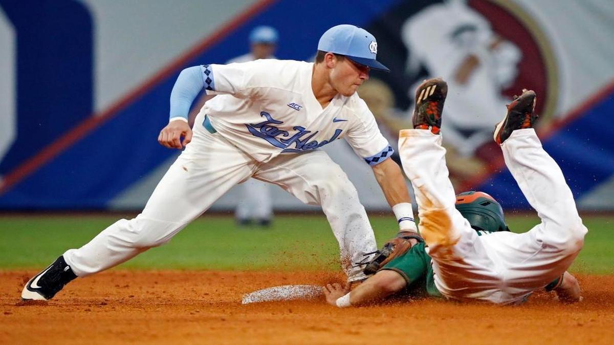 North Carolina shortstop Logan Warmoth tags out Miami’s Michael Burns at second base during an Atlantic Coast Conference semifinal game on Saturday in Louisville, Kentucky.