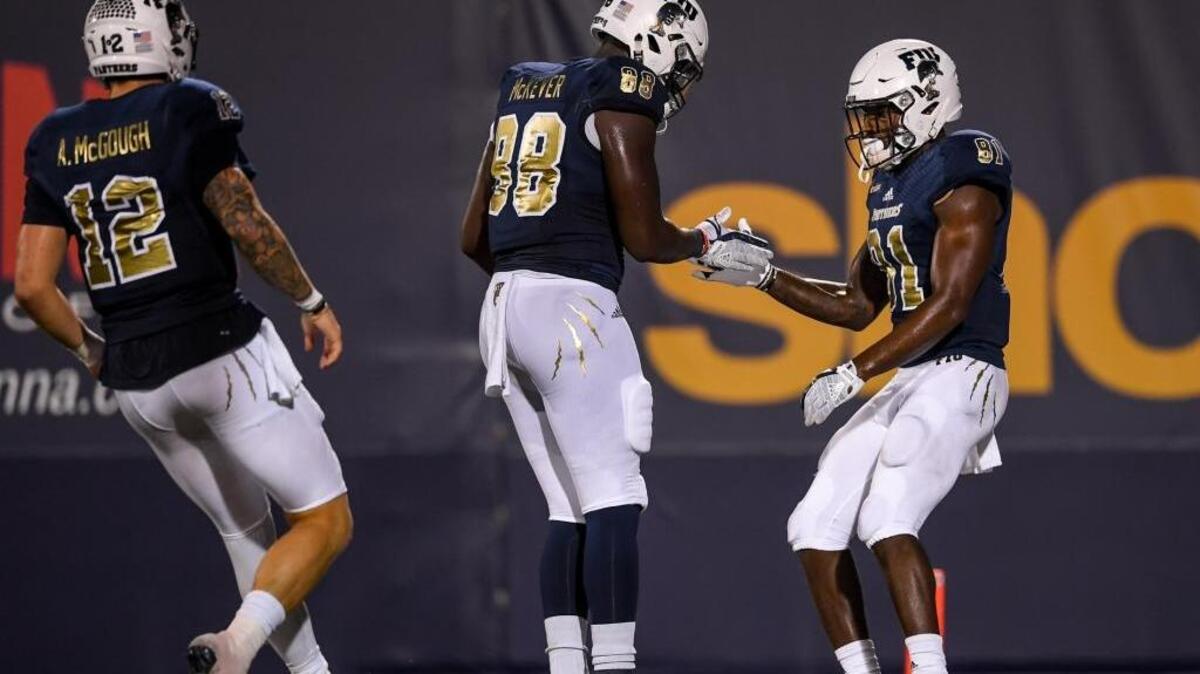 FIU wide receiver Thomas Owens (81) celebrates with tight end Pharoah McKever (88) and quarterback Alex McGough (12) after scoring a touchdown during the second half UTSA Saturday.