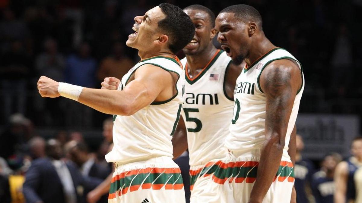 UM guard Angel Rodriguez, left, celebrates with teamates Davon Reed and Ja’Quan Newton after scoring the winning shot against Pittsburgh at BankUnited Center on Tuesday, February 9, 2016.