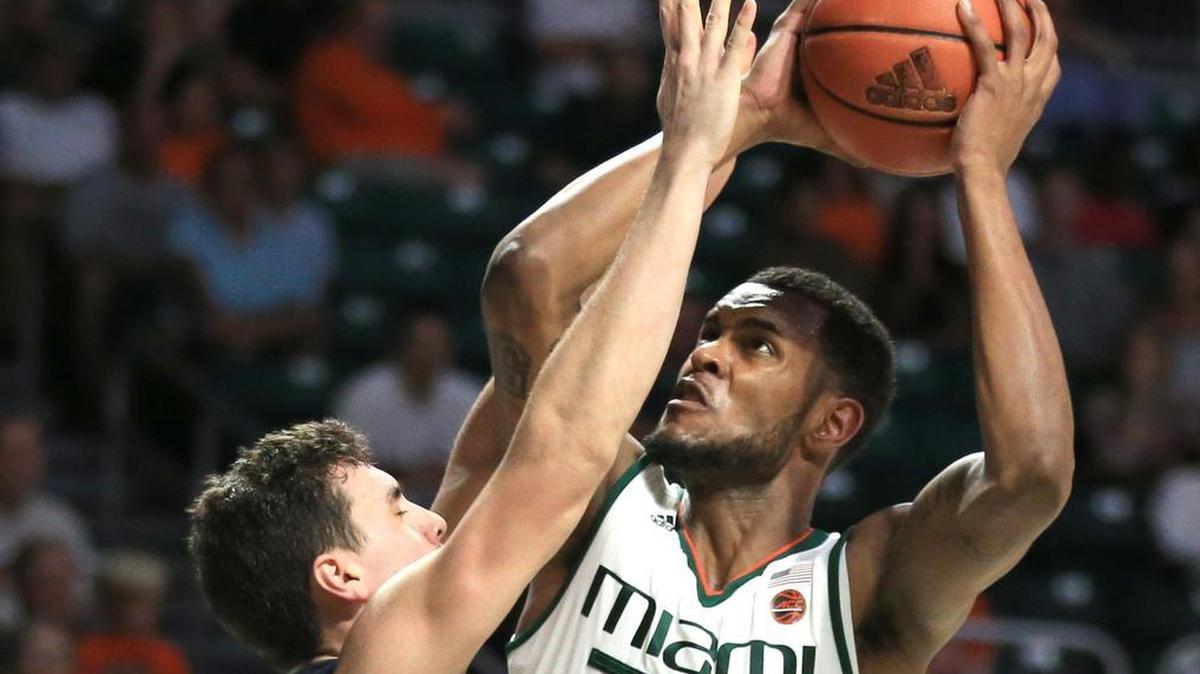 Miami Hurricanes forward Dewan Huell (20) is fouled by North Florida Ospreys forward Trip Day (22) on Nov. 25.