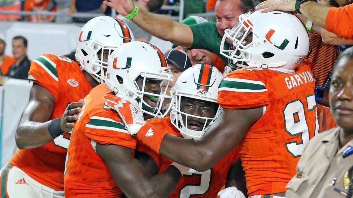 Miami Hurricanes cornerback Trajan Bandy (2) celebrates with teammate after a pick-six in the second quarter against Notre Dame at Hard Rock Stadium in Miami Gardens, Florida, Nov. 11, 2017.