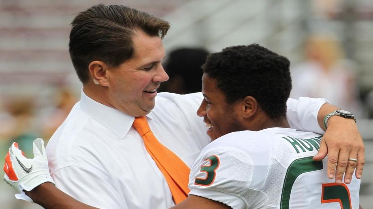 Then-UM coach Al Golden embraces cornerback Tracy Howard before a game against Boston College at Chestnut Hill, Mass., on Saturday, Sept. 1, 2012.